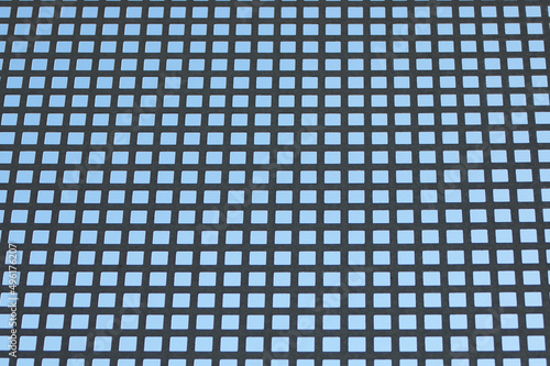 blue background  in the photo a metal grid with square cells on a blue background.