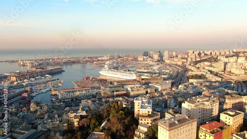 aerial view drone of genova historic city center and port italy,panoramic view of italian town of genoa at sunrise flying forward over old downtown 4k photo