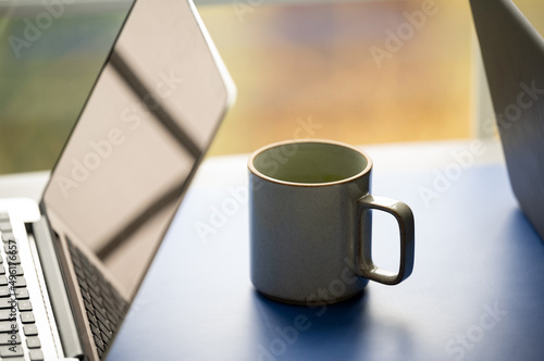 Mug of tea by laptop