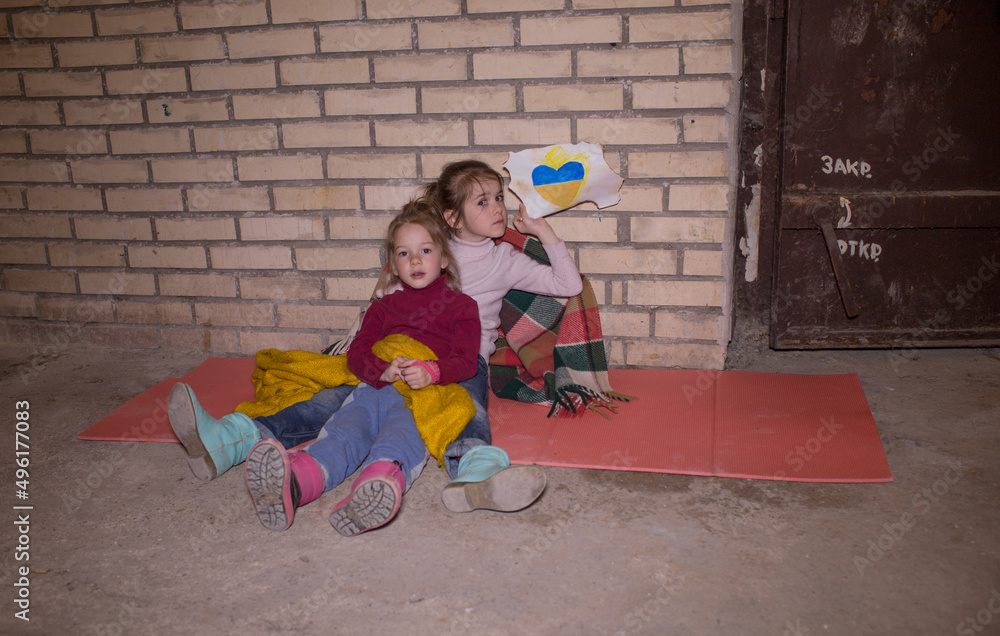 Fototapeta premium KIEV, UKRAINE - March 24, 2022: The war in Ukraine. the life of children in a bomb shelter at a metro station in Ukraine.