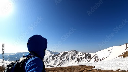 Man taking selfies with backpack hiking. Scenic view on snow capped mountain peaks of Seetaler Alps in Styria, Austria. Winter wonderland on sunny day in the Austrian Alps, Europe. Ski tour, snow shoe photo