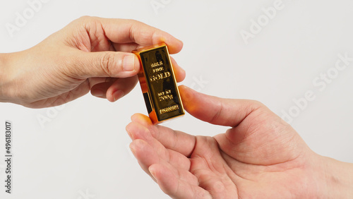Two hands send and recive gold bar on white background.