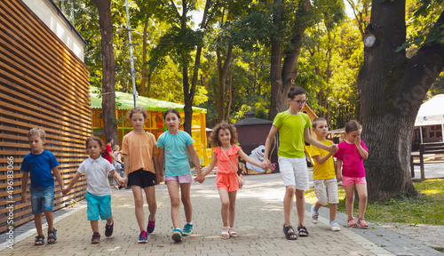 The group of excited preschoolers are running together