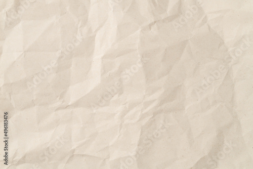 Wrinkled sheet of recicled paper. Textured backdrop photo
