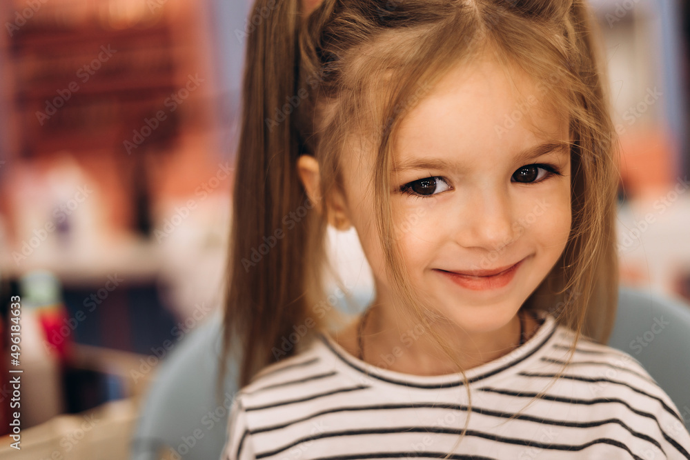 Portrait of a little beautiful girl with a stylish hairstyle in a beauty salon Portrait of a little beautiful girl with a stylish hairstyle in a beauty salon
