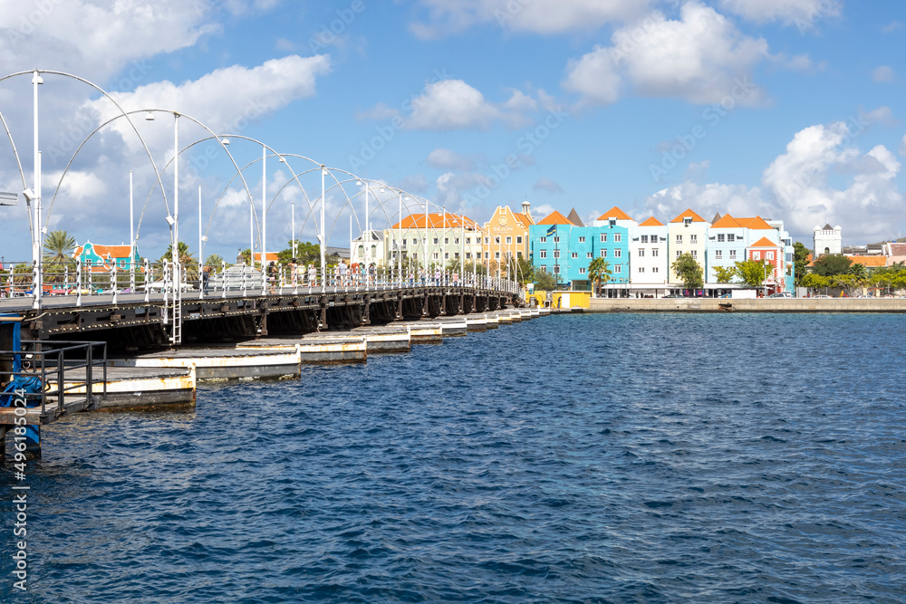 The famous Queen-Emma-Bridge with colorful buildings of the district Otrobanda in Willemstad, Curacao