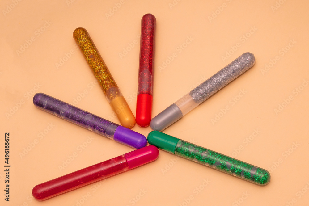 Gel sparkling pens on yellow background