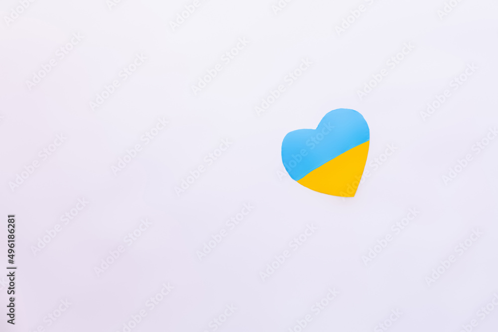 Top view of ukrainian flag in heart shape on white background. Top view of ukrainian flag in heart shape on white background.