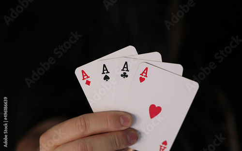 Four aces in the hand as a symbol for game