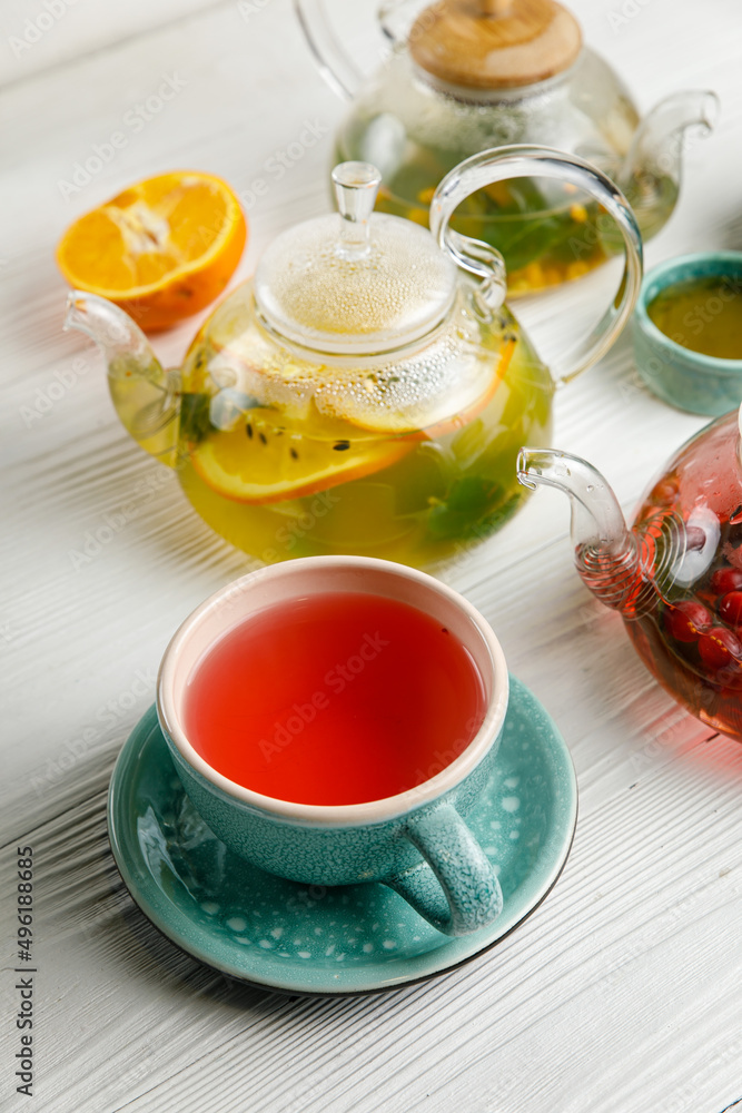 Hot tea in teapots on a wooden table
Hot tea in teapots on a wooden table