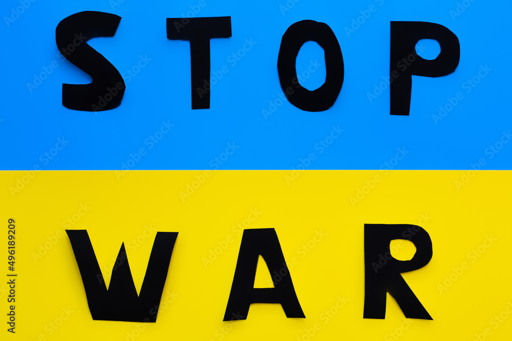Top view of stop war lettering on ukrainian flag. Top view of stop war lettering on ukrainian flag.