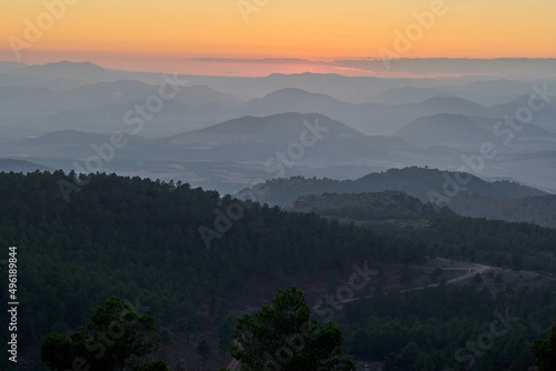 Nice sunset between mountains. Pedro ponce mountains sunset with a dense forest mainly of pine trees.It is located between the municipal districts of Mula and Lorca, Murcia, Spain. © Jose Aldeguer