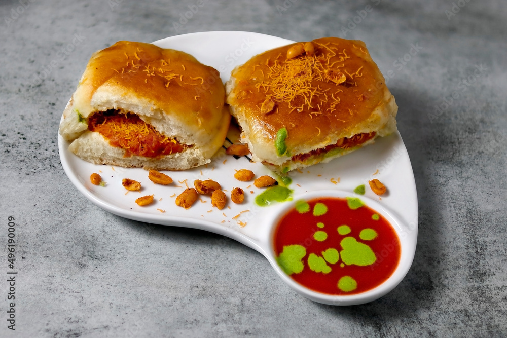90 degree angle shot photo Dabeli is an Indian snack item served with peanut and sev bhujia in