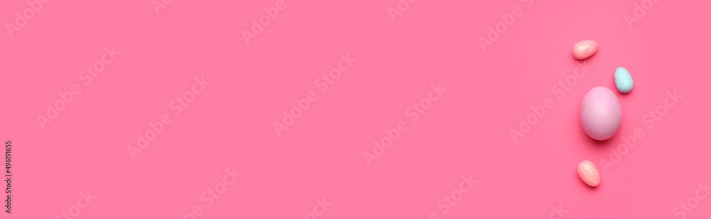 Painted Easter eggs on pink background with space for text Painted Easter eggs on pink background with space for text
