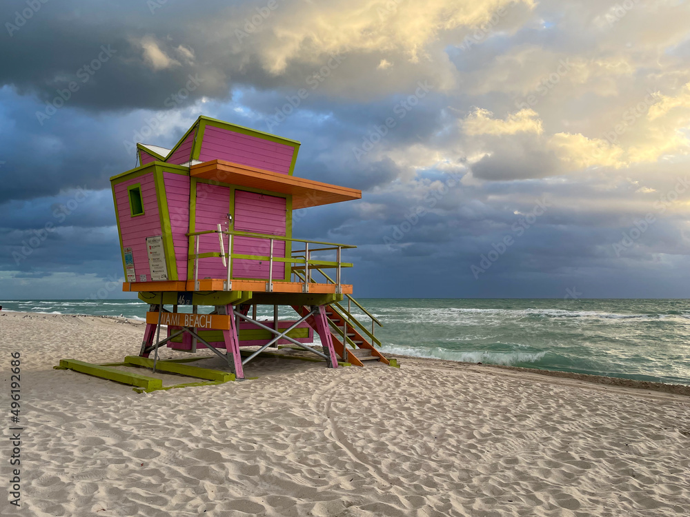 Iconic orange and pink lifeguard house in Miami Beach. Beautiful sky at sunrise Iconic orange and pink lifeguard house in Miami Beach. Beautiful sky at sunrise