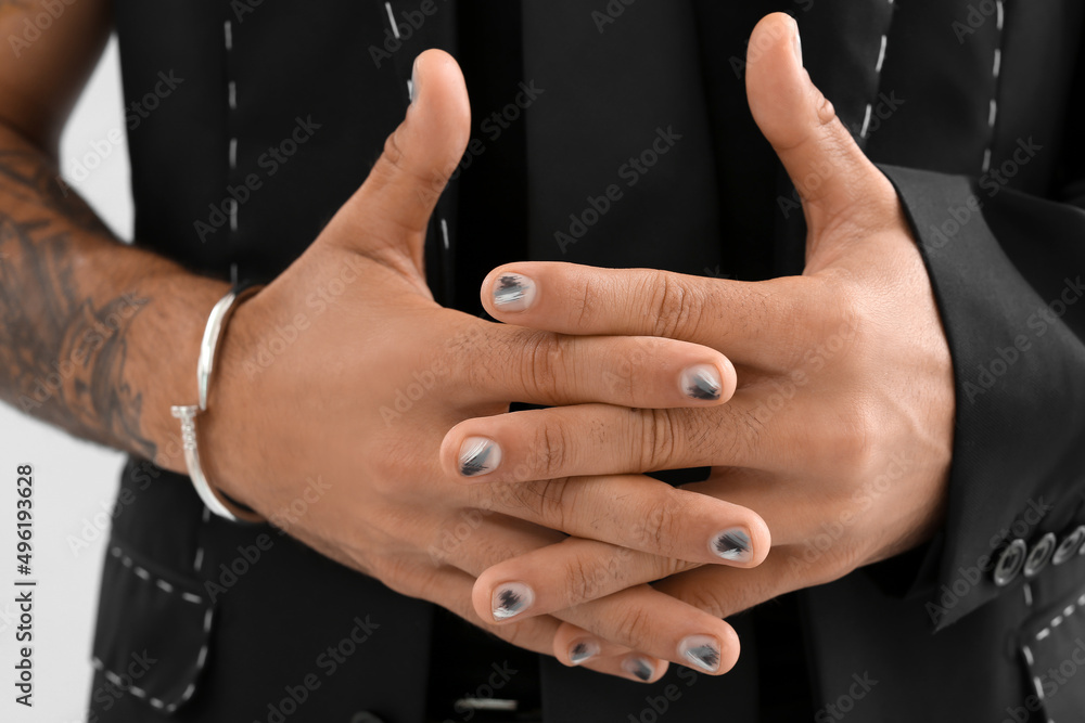 Man with stylish manicure and crossed fingers, closeup