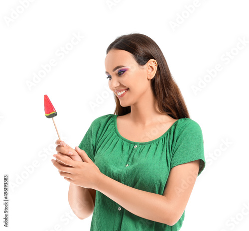 Young woman with lollipop in shape of watermelon on white background