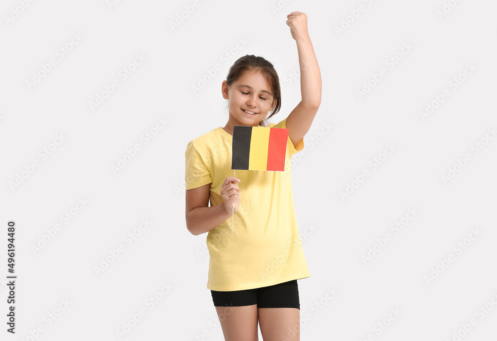 Happy little girl with flag of Belgium on light background Happy little girl with flag of Belgium on light background