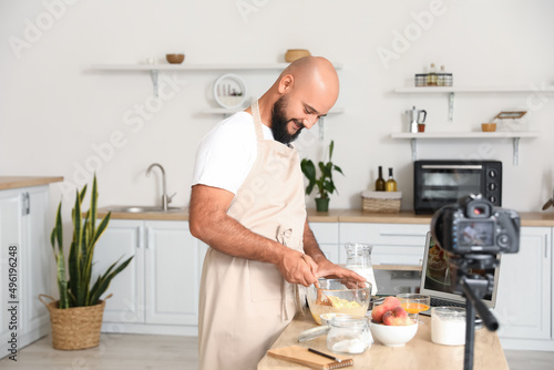 Handsome man making dough w...