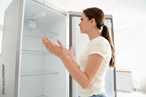 Confused woman near empty f...