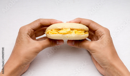 Hands holding venezuelan corn arepa typical breakfast 
 photo