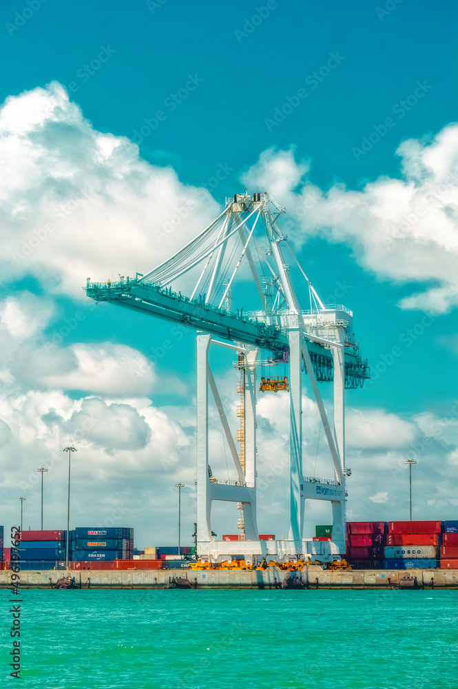 Aerial view over cargo cranes and ships in cargo port of Miami, Florida, USA.