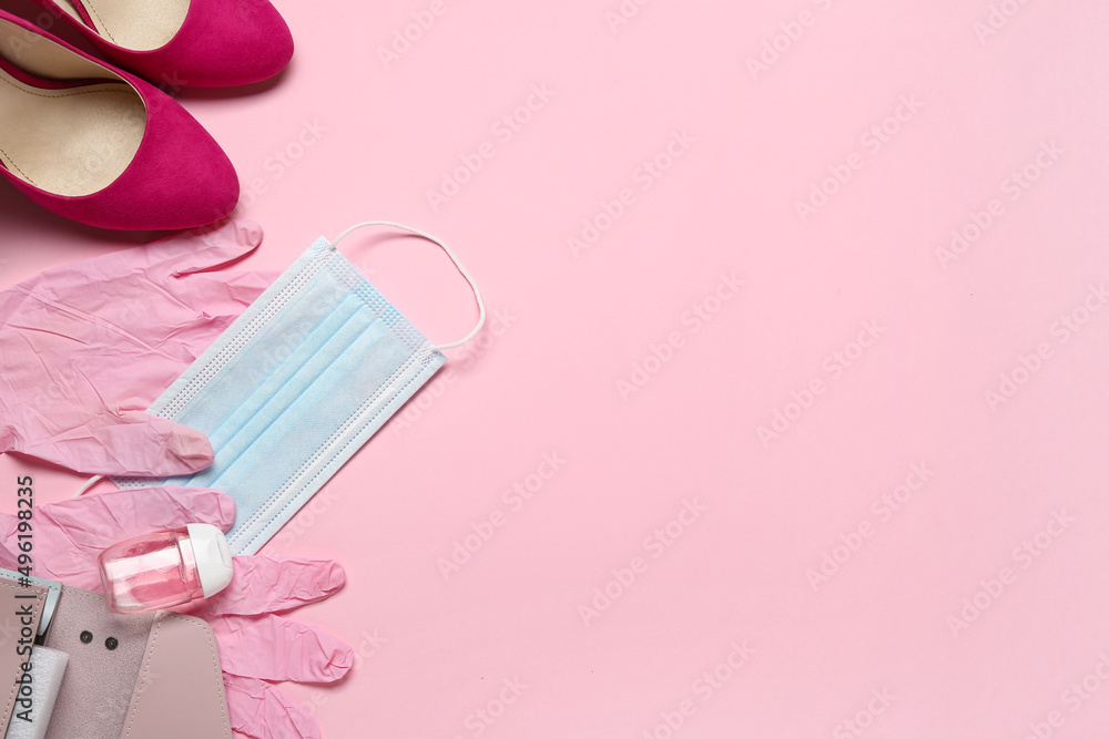 Female accessories, medical mask, gloves and bottle with antiseptic on color background