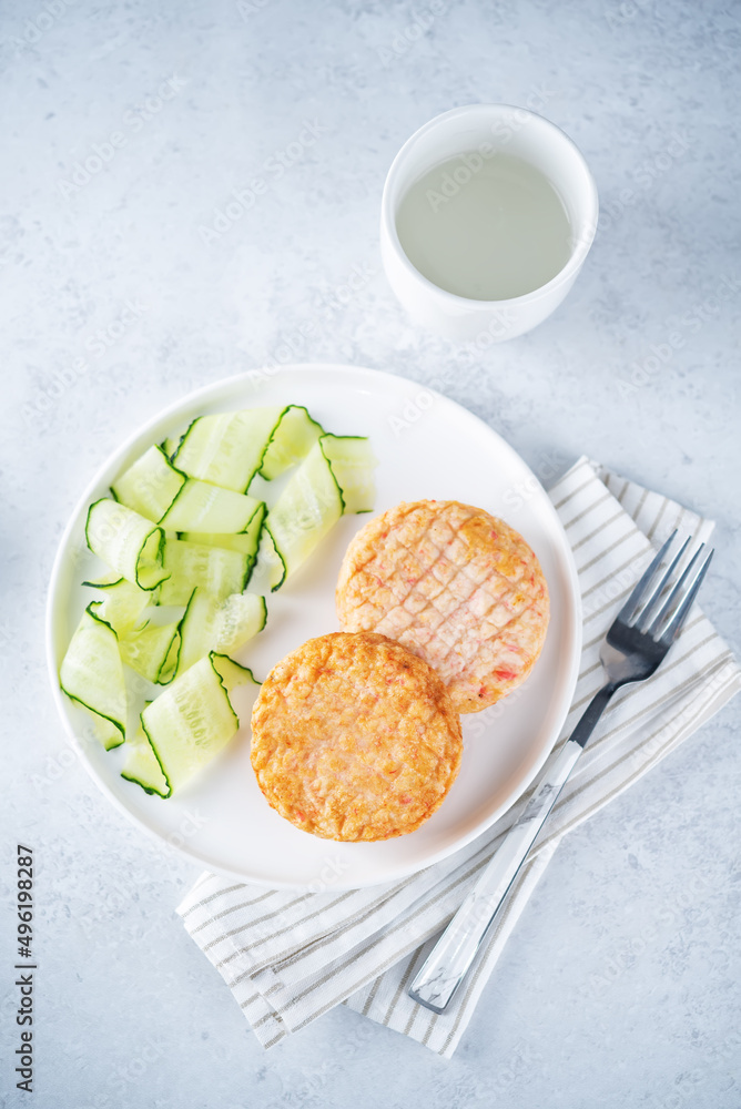 Shrimp patties with cucumber in a plate Shrimp patties with cucumber in a plate