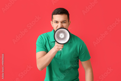 Angry young man shouting in...