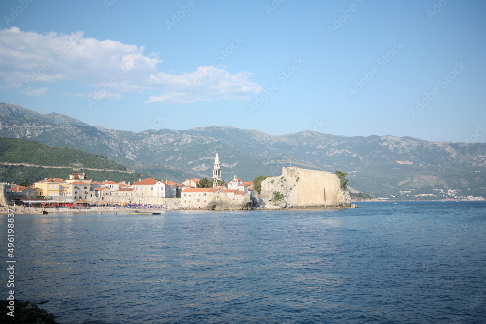 View of old town Budva on mountains background, Montenegro. The resort city located in Budva Riviera of Adriatic Sea for poster, branding, calendar, card, banner, cover, post. A place for your design