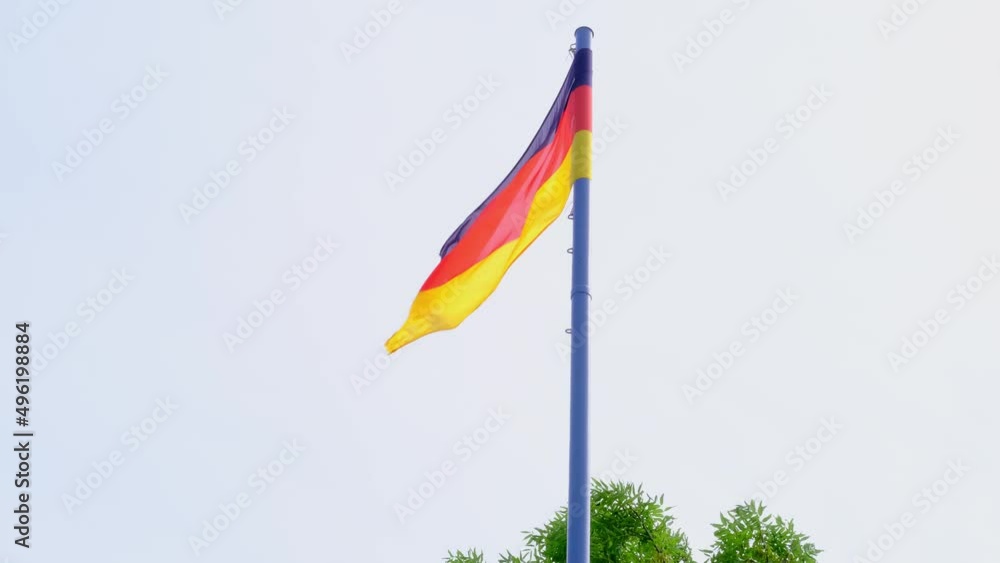 Germany national flag on satin fluttering in the wind in the blue sky, state symbol, country elections concept, international cooperation, global business Germany national flag on satin fluttering in the wind in the blue sky, state symbol, country elections concept, international cooperation, global business