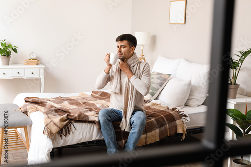 Ill young man with sore thr...