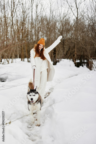 Fototapeta Naklejka Na Ścianę i Meble -  cheerful woman winter outdoors with a dog fun nature winter holidays