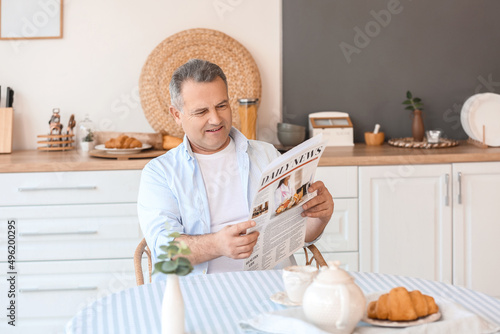 Senior man reading newspape...