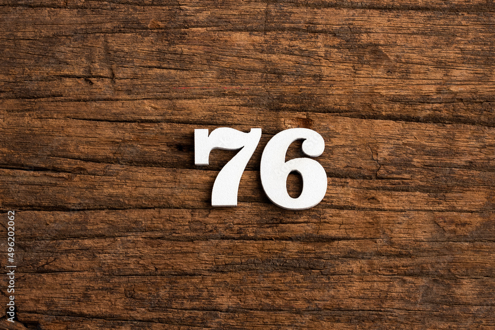 Obraz premium Number 76 - piece on rustic wood background