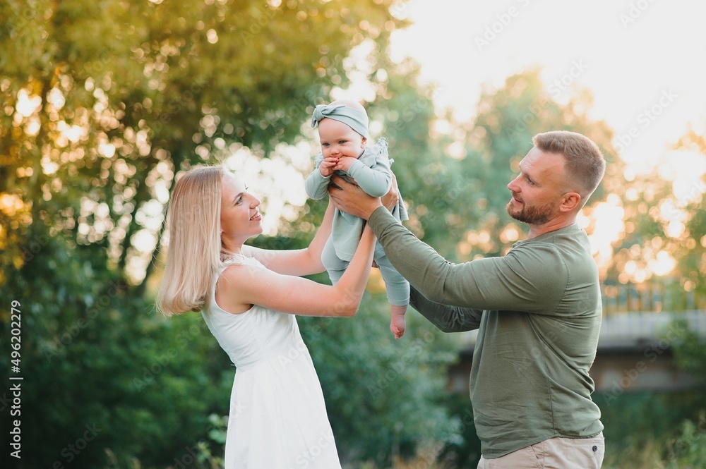 Happy young family spending time together outside in green nature. Happy young family spending time together outside in green nature.