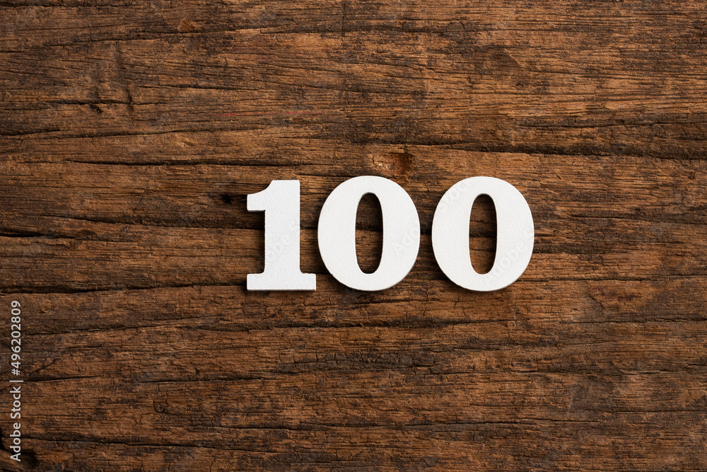 Number 100 - piece on rustic wood background Number 100 - piece on rustic wood background