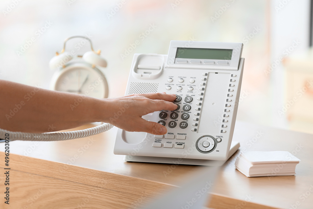 Mature secretary dialing phone number in office Mature secretary dialing phone number in office