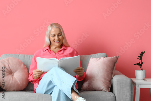Mature woman reading book w...