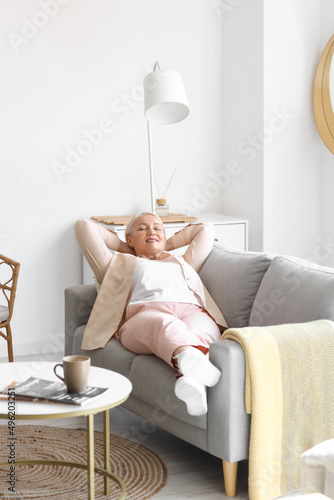 Mature woman relaxing on so...