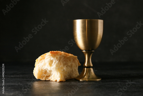 Foto Cup of wine with bread on dark background