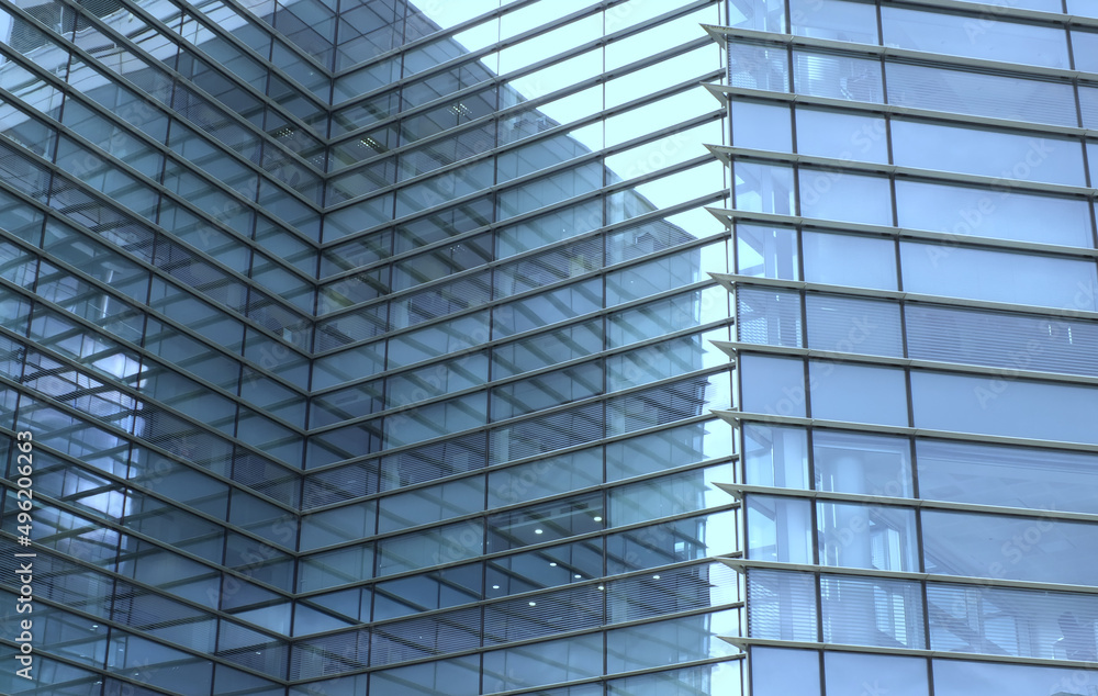 Obraz premium full frame modern urban office architectural abstract with geometric shapes and buildings reflected in blue glass windows