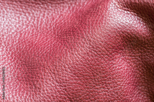 A selective focus on real cowhide leather with its grainy texture. Full grain leather background