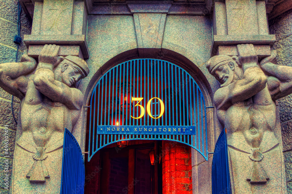 A marble statue used as architectural decoration at entrance to the store in Stockholm, Sweden.