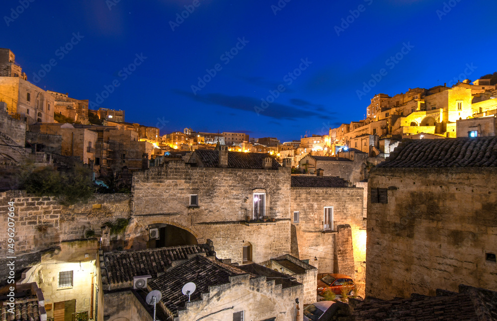 Night view of the ancient city of Matera Italy including the ancient cave homes and outer wall in the Basilicata region of Matera, Italy.	