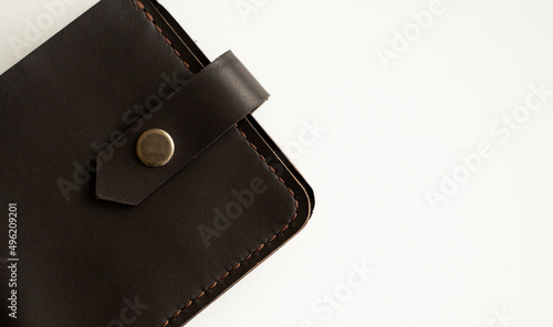 Top view of brown empty man's black handmade genuine leather wallet for banknotes and credit cards isolated on white background. Selective focus, copy space, Close up.