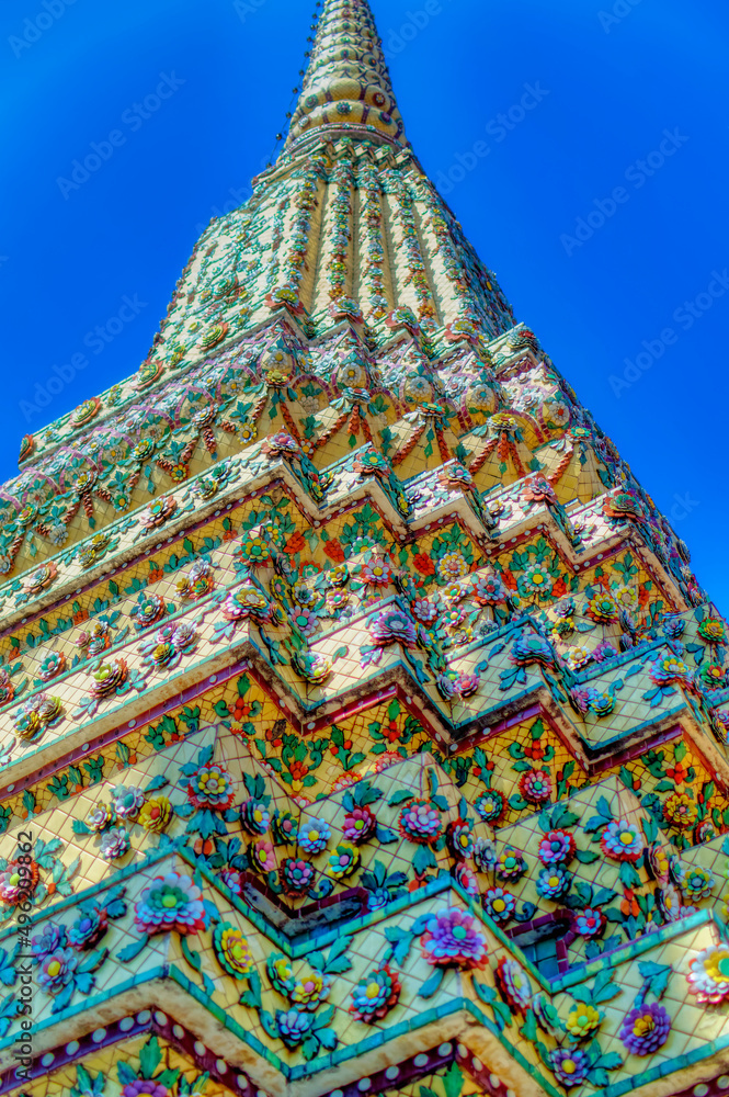 Colorful traditional decorations at Buddhist temple structures in Thailand.
