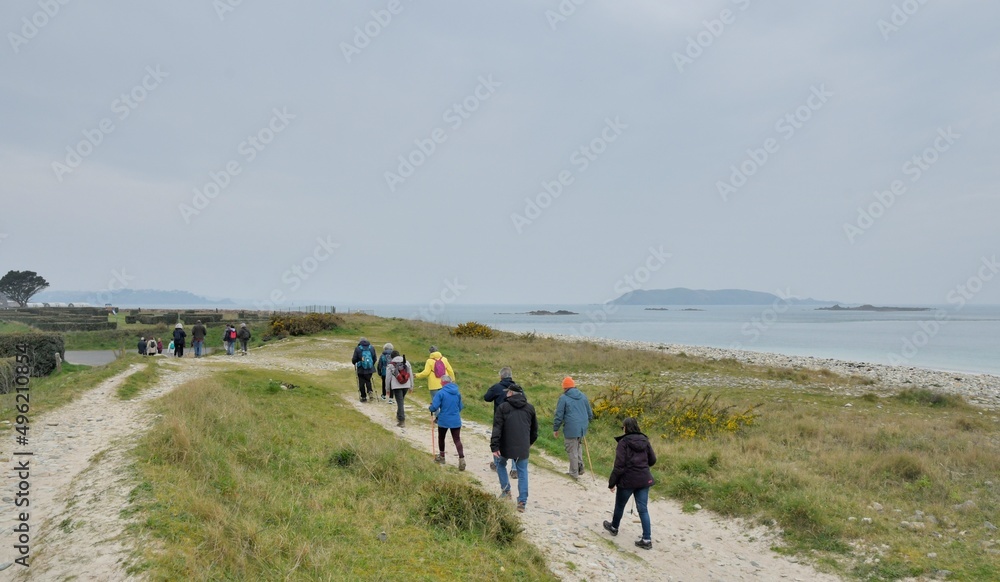 Group of senior hikers walking on a path in Brittany. France