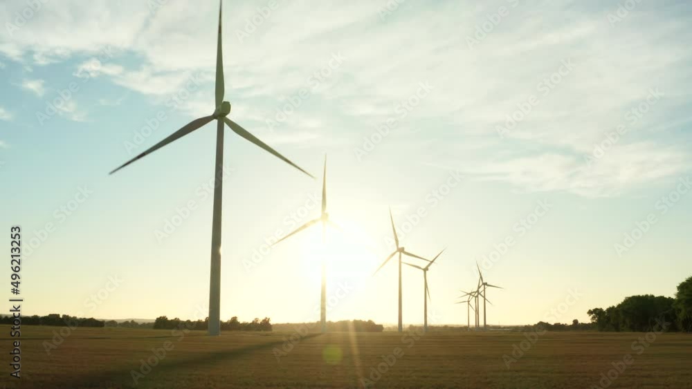 Wind turbines in a field on a beautiful sunset aerial view. Wind turbines in a field on a beautiful sunset aerial view.