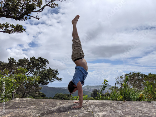 Man in Handstand on top mountain